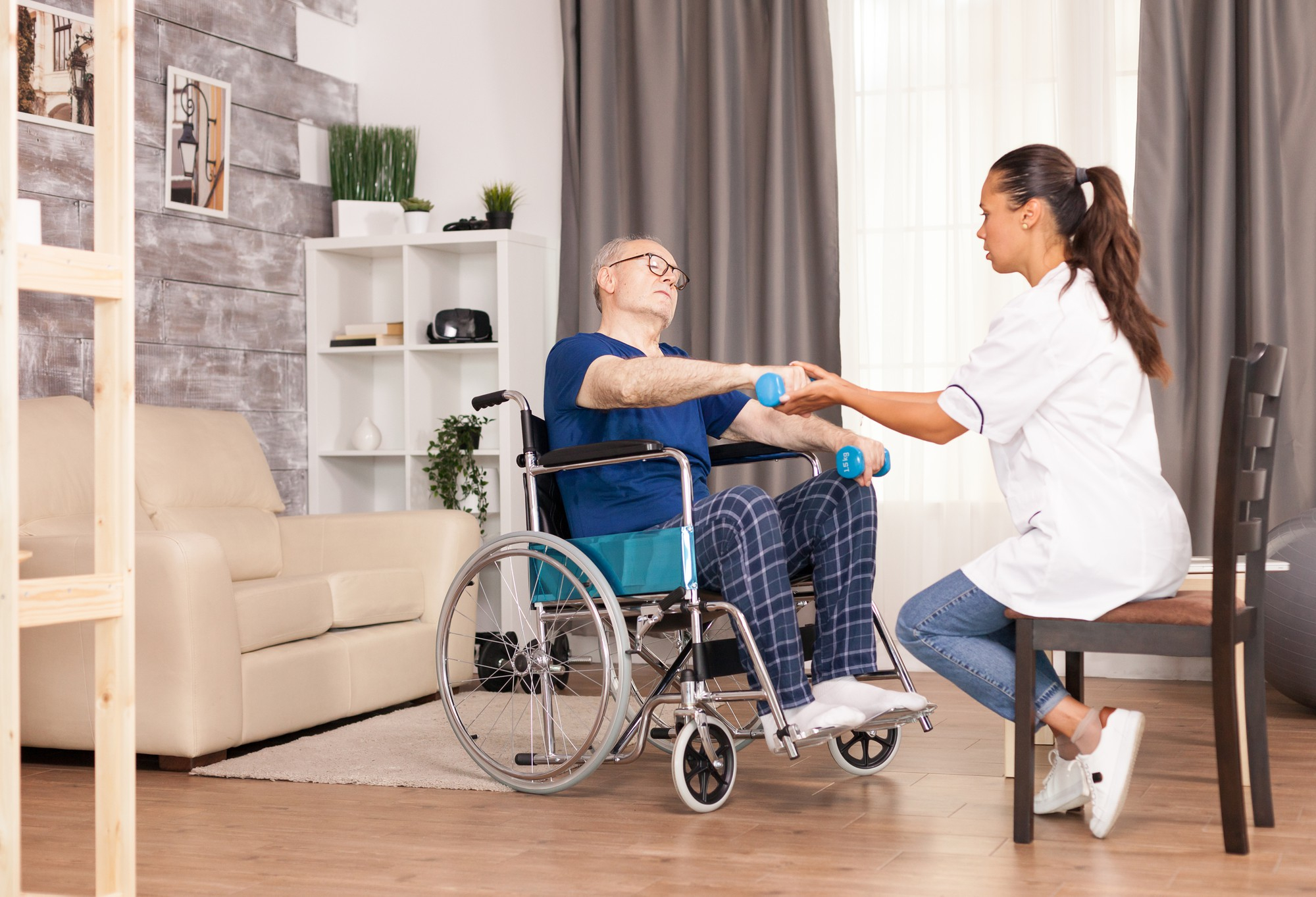 person with disabilities sitting wheelchair training with dumbbells