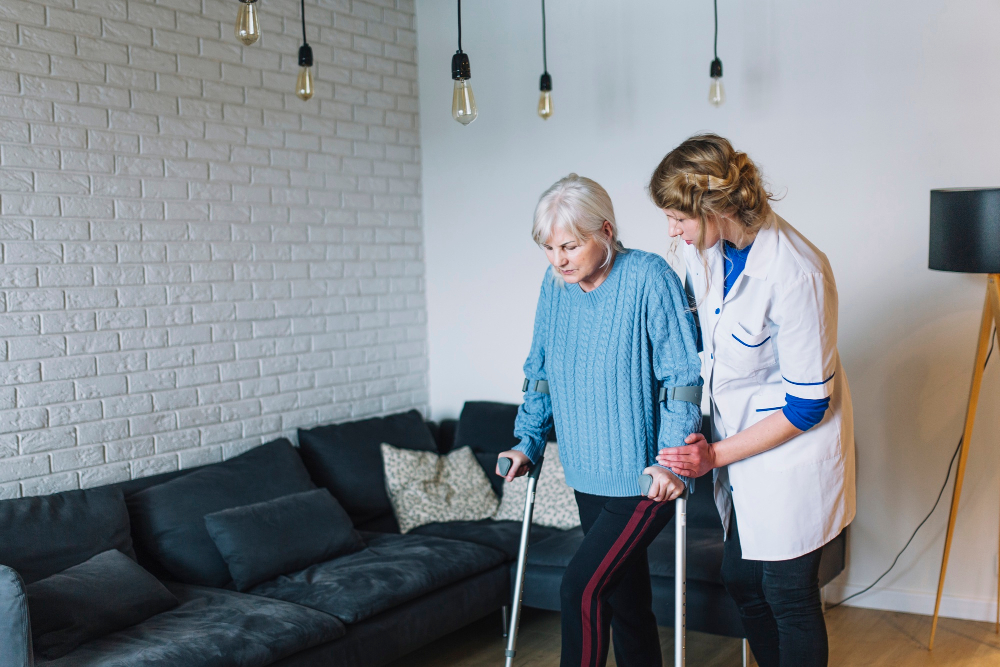 An elderly woman receiving support from a professional female physician while walking.